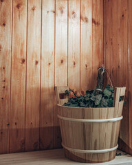 russian steam room in wood with broom and bucket