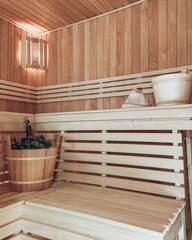 russian steam room in wood with broom and bucket