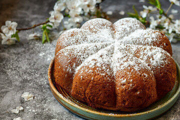 Homemade  Italian style  Easter  bread cake, spring blossom  and  hand colored eggs. Homemade pastry.  Easter holiday baking and decorarion