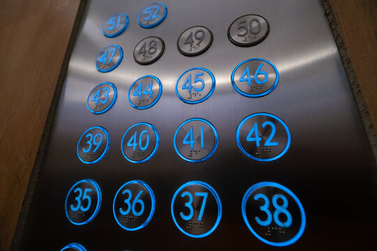 Close-up Of Blue Glowing Elevator Buttons With Braille Characters, Numbers From The 35th Floor To The 52nd Floor