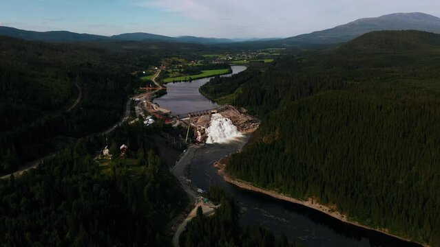 Aerial view towards a dam, in cloudy Trondelag, Norway - approaching, drone shot