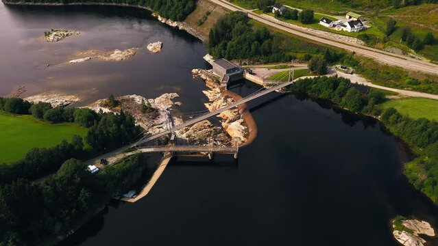 Aerial view around a dam, summer day in Norway - high angle, orbit, drone shot