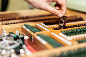 Optician hands choosing lenses from set of corrective lens indicating on the correction. Selective focus