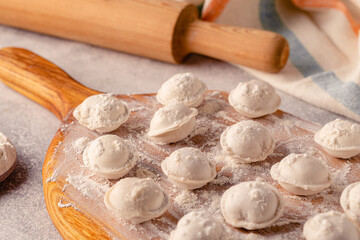 Homemade raw dumplings on the board.