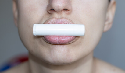 close up of bottom of the face of a woman using natural ingredients lip balm, white blank pack....