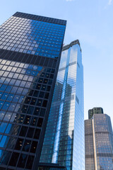 Fototapeta na wymiar Tall office skyscrapers are under blue sky, London