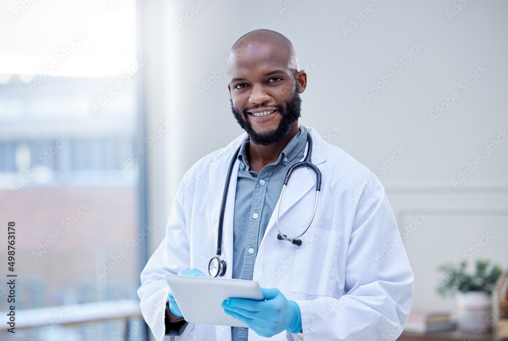 Poster use the app to make an appointment. shot of a male doctor using a digital tablet.