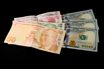 Turkish lira banknotes and American dollars on a black background