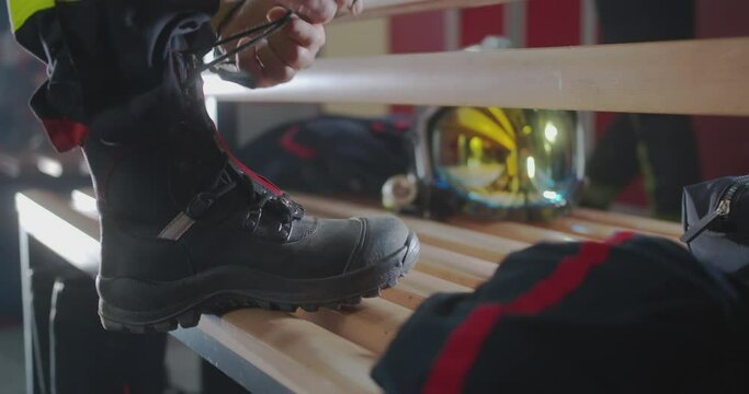 
a fireman ties these shoelaces