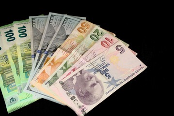Turkish lira banknotes and American dollars on a black background