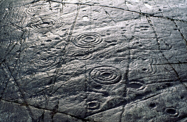 Cup and ring mark marks prehistoric Neolithic rock art on natural rock outcrop at Achnabreck in Kilmartin Valley, Argyll, Scotland, UK