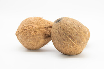 Two whole coconut closeup over on white background