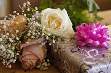 Bouquet of white and rose flowers and gift for birthday. High quality photo