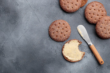 Ruisleipa - traditional Finnish rye bread with butter on a gray concrete