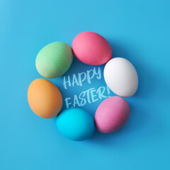 Preparation for the Easter holiday. Eggs and Easter decor on a bright background.