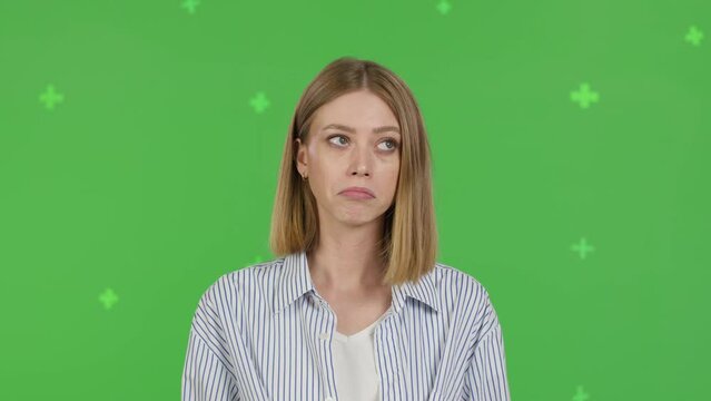 Close-up of thinking girl. Young pretty woman on green screen background, Chroma Key 4k video footage slow motion 60 fps