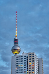 The famous TV Tower of Berlin at dusk with a typical GDR prefabricated apartment building © elxeneize