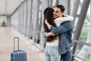 Long Awaited Meet. Happy Arab Man Hugging Girlfriend At Airport After Arrival