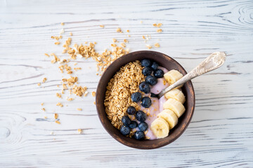 granola, yogurt, blueberries and bananas field breakfast