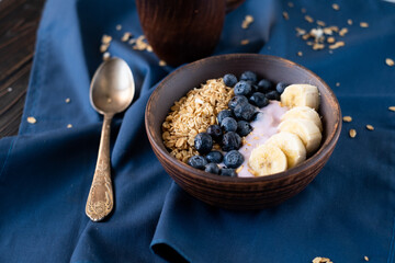 granola, yogurt, blueberries and bananas field breakfast