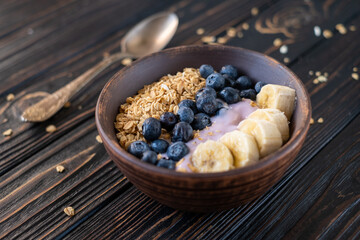 granola, yogurt, blueberries and bananas field breakfast