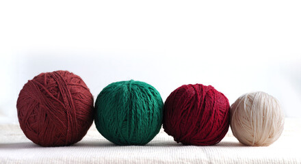 Balls of yarn in different colors on a light background.