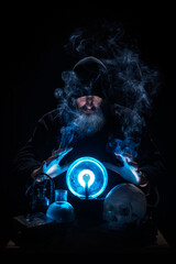 Warlock guessing the future with a blue crystal ball, surrounded by smoke, books, a skull and...