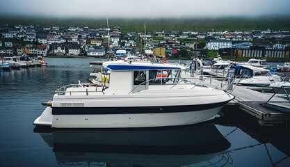 Fototapeta premium Fishing and sailing boats in the harbour of Klaksvik city in Bordoy island (Nordoyar) Faroe Islands, Denmark, Europe