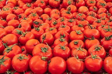 a lot of tomatoes on the market on the counter, the background