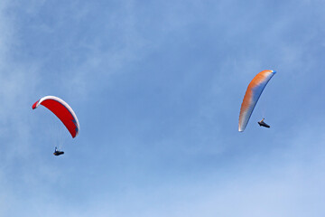 Paragliders in a blue sky	