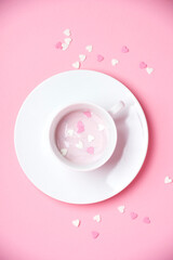 cup with yogurt and sugar hearts