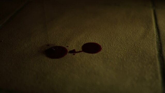 Blood dripping onto tiled floor