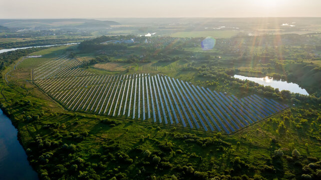 View of a solar power plant, rows of solar panels, solar panels, top view, top view of a solar power plant, industrial background on the theme of renewable resources, power plant