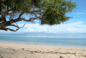 Fototapeta na wymiar Beautiful view of Cristo Rei Backside Beach or known as Dolok Oan Beach in Dili, Timor Leste. Beach background.