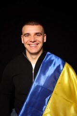 Ukraine flag on black background. war in Ukraine. patriot of his state. yellow and blue flag. Love your country. Victory Day in the war