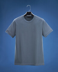 Volumetric T-shirt hanging on hanger, dark blue background colours, grey, beige, blue.