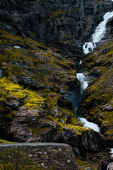 Photo showing a bridge on a Trollstigen over an astonishing waterfall.