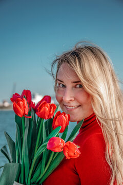 woman with a bouquet of red tulips 