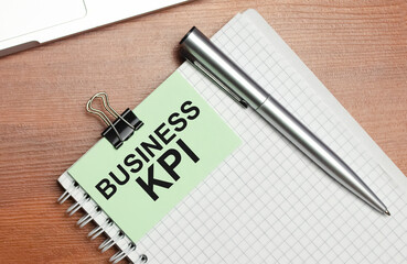 business KPI - gray background, top view on notepad with text.