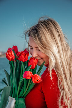woman with a bouquet of red tulips 