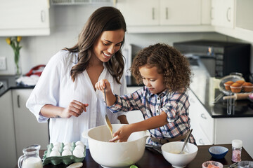 Precious child, proud and true. Shot of an adorable little girl baking with her mom at home.