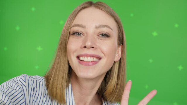 Young woman teenager speaking on video call, vlogger using smartphone talking at camera webcam online, selfie call, record lifestyle vlog, blogger online streaming on green screen . Chroma key