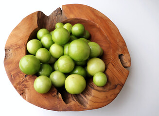 Autumn vegetables still life composition. Tomatillo on a white background.Seasonal sale concept, no people. Closeup of blank business card mock-up.Concept of diet and healthy food.