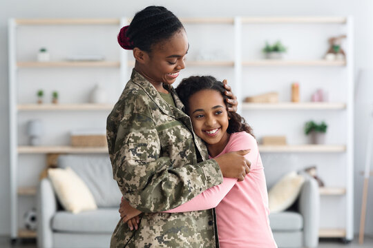 Adorable African American Girl Hugging Her Mother Soldier