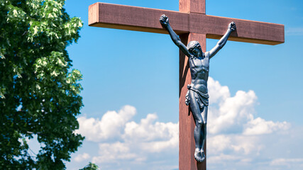 statue of the crucified jesus on a wooden cross