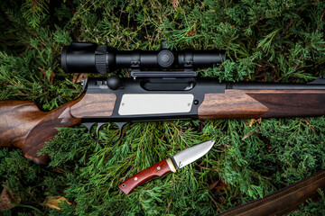 Close-up of a luxury hunting rifle with an optical sight. Bolted carbine with a wooden stock....
