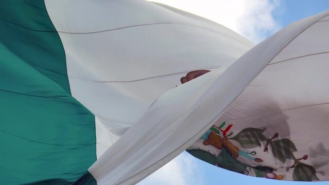 Big Mexican Flag Floating on the wind in slow motion. Close up.