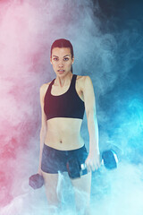 Looking strong, feeling fly. Shot of a young woman working out with dumbbells.