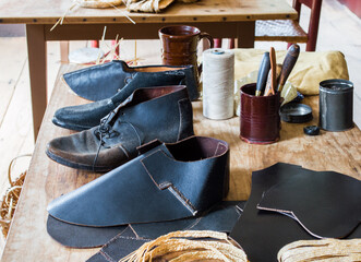 colonial cobbler's work bench with shoes and boots
