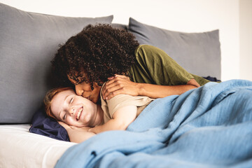 tender awakening of a couple of lesbian girlfriends, african woman kissing her wife, daily moments of a LGBT couple